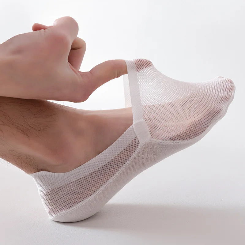A pair of breathable mesh socks made for men, featuring anti-slip detail, excellent for hot summer weather. These innovative socks present a shallow “invisible” design suitable for modern low-top shoes, accompanied by a cotton sole designed for all-day softness and comfort. Displaying a unique ship's sock style, it adds a casual nautical touch to any leisure outfit. These are low-barrel, easy-care socks combining comfort and superior knitting technology.